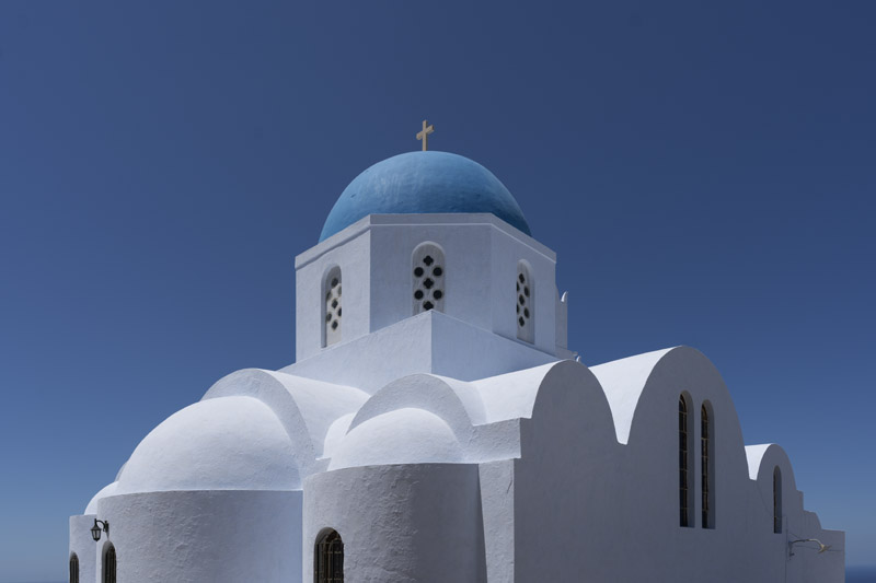 Blue domed church at Pyrgos under a bright blue sky