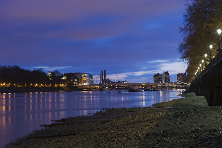 View of Albert Bridge and Battersea from banks of River Thames