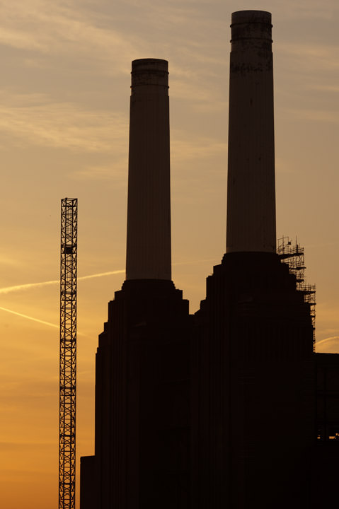 Two chimneys of Battersea Power Station at sunrise