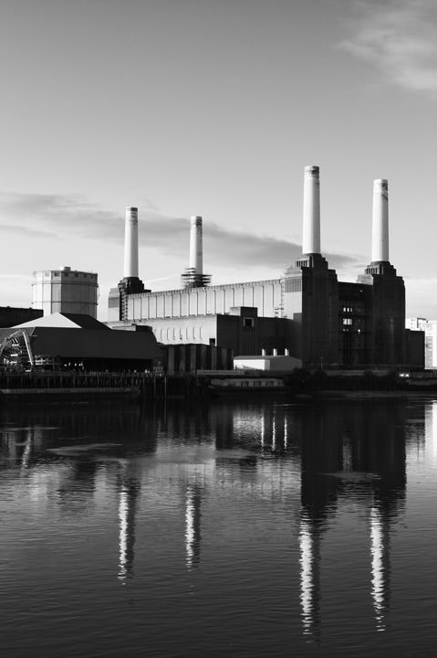 Black and white vertical photo of Battersea Power Station and reflection
