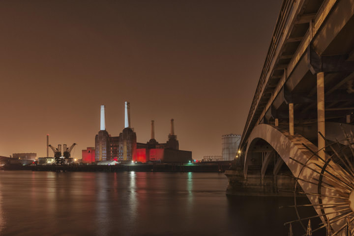 Battersea Power Station lit in red and white and Grosvenor Bridge  at Night