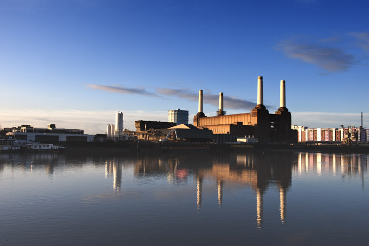 Dominant blue photo of Battersea Power Station and its reflection in the River Thames