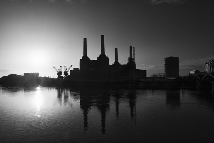 Sun rises behind Battersea Power Station in this black and white photo