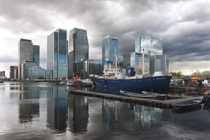 Canary Wharf in storm clouds including Lord Amory boat