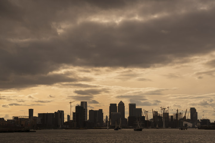A Canary Wharf Cityscape silhouetted against yellow skies
