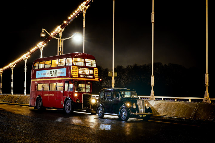Vintage red bus and vintage taxi on Chelsea Bridge in London