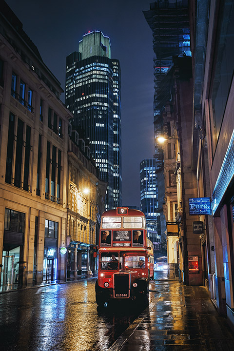 London Bus in front of Tower 42 at night