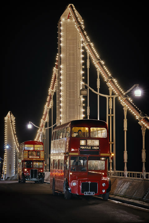 Two vintage London buses on Chelsea Bridge
