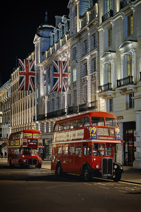 2 London Buses beneath Union Jacks