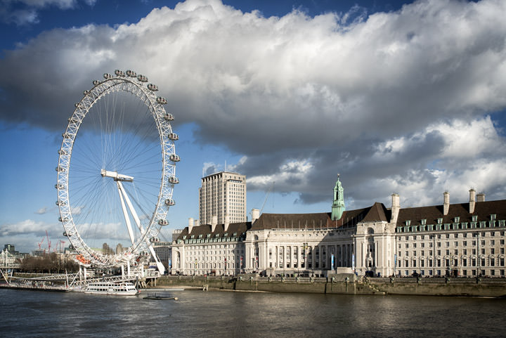The London Eye beneath dramatic clouds in daytime