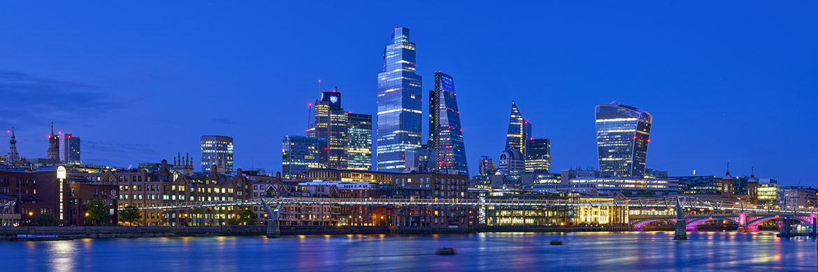 London Skyline At Dusk with blue sky and city buildings with twinkling lights