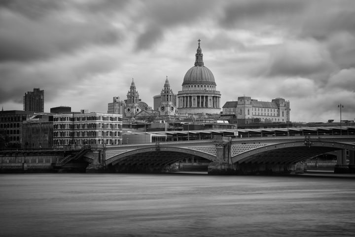 Dramatic shot of St Pauls Cathedral and Blackfriars Bridge in black and white