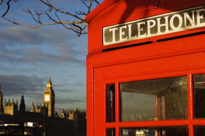 A red London Telephone Box with Big Ben in the background