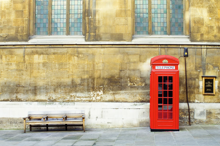 A red Telephone Box and bench outside a London church