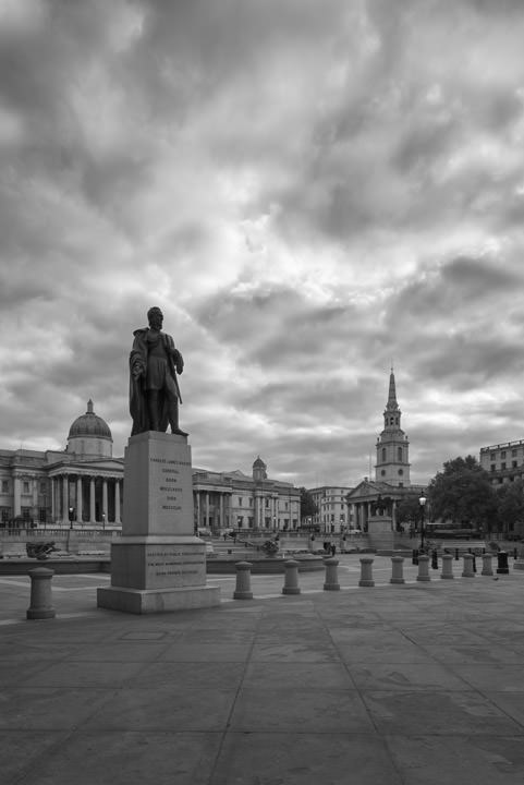 Black and white photograph of Trafalgar Square in the early morning.