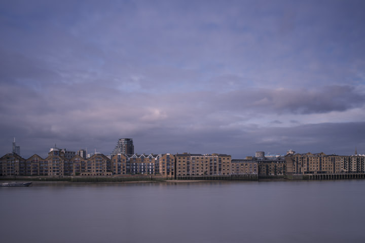 Wharves at Wapping along the River Thames at Tower Hamlets in purple skies