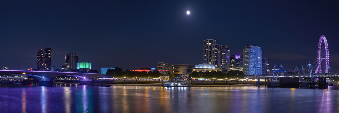 Moon Over London Southbank wide sweeping panorama of colourful buildings