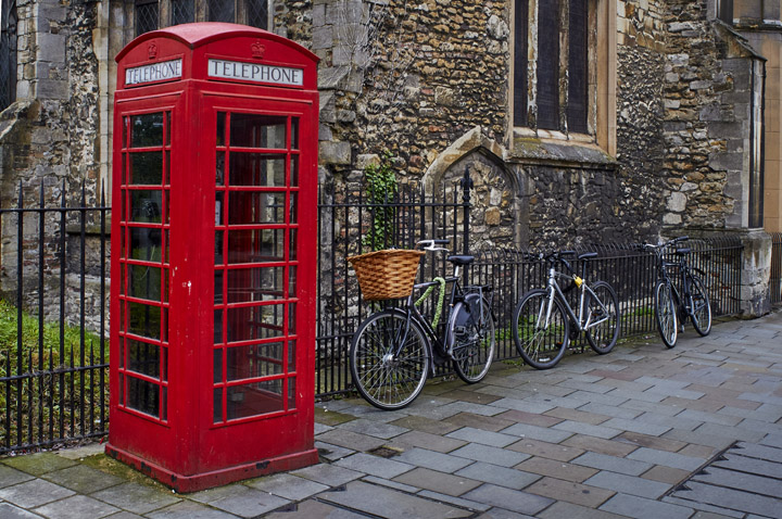 Streets of Cambridge with red telephone box and student bicycles