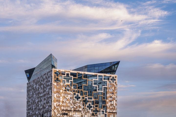 Colourful image  of The Cube Birmingham under beautiful clouds